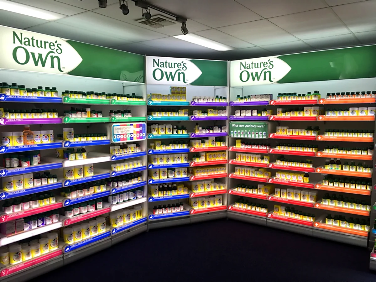 Retail gondola shelves lit with ULIGHT 1010 magnetic LED bars in a store display